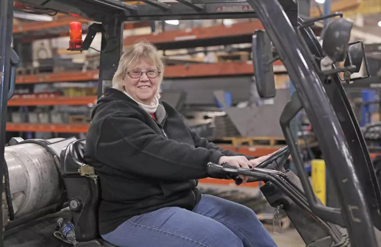 KUHN employee driving a forklift